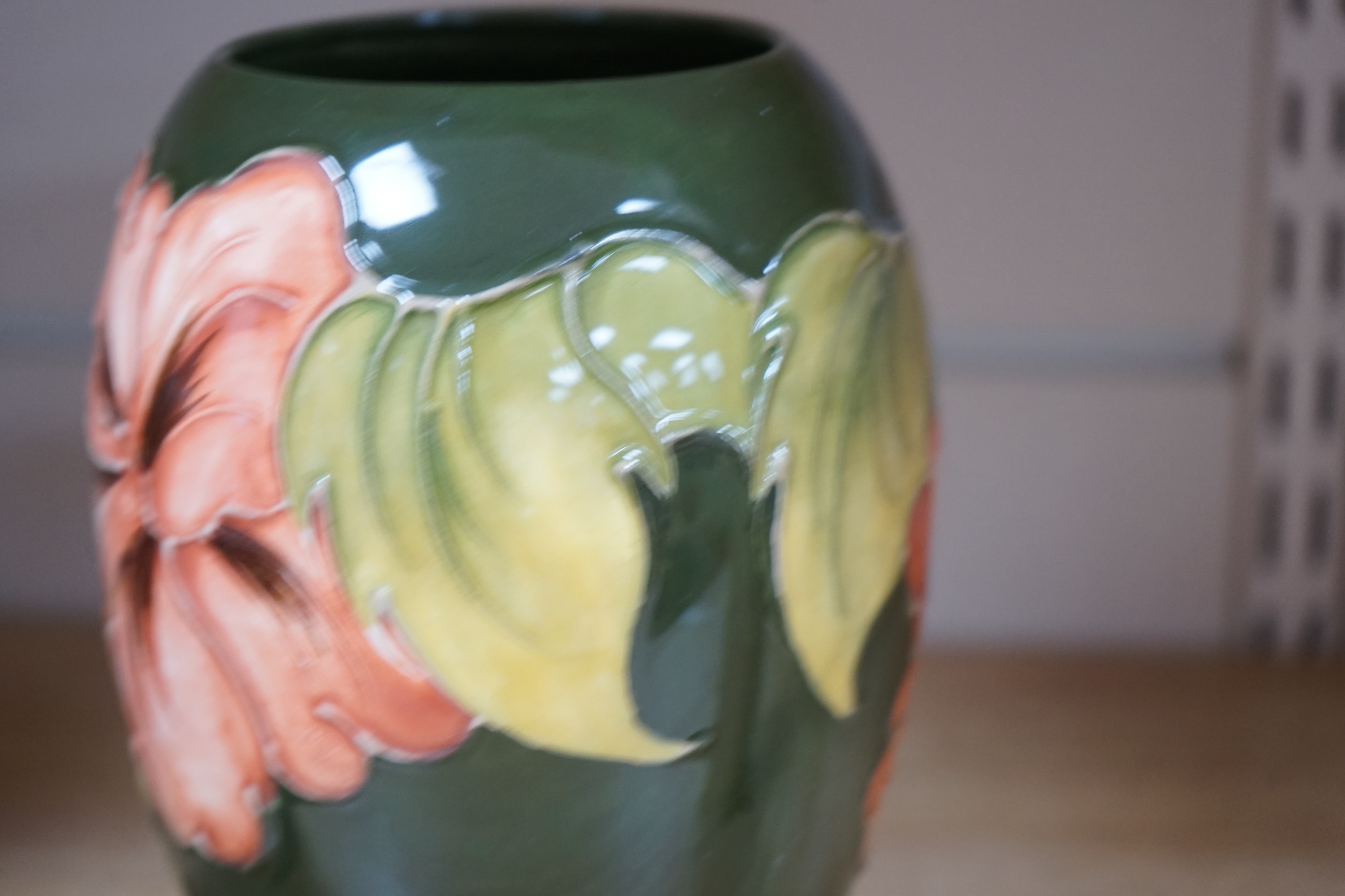 Three 1990's Moorcroft vases, Hibiscus and Lamia pattern, tallest 26cm. Condition - good